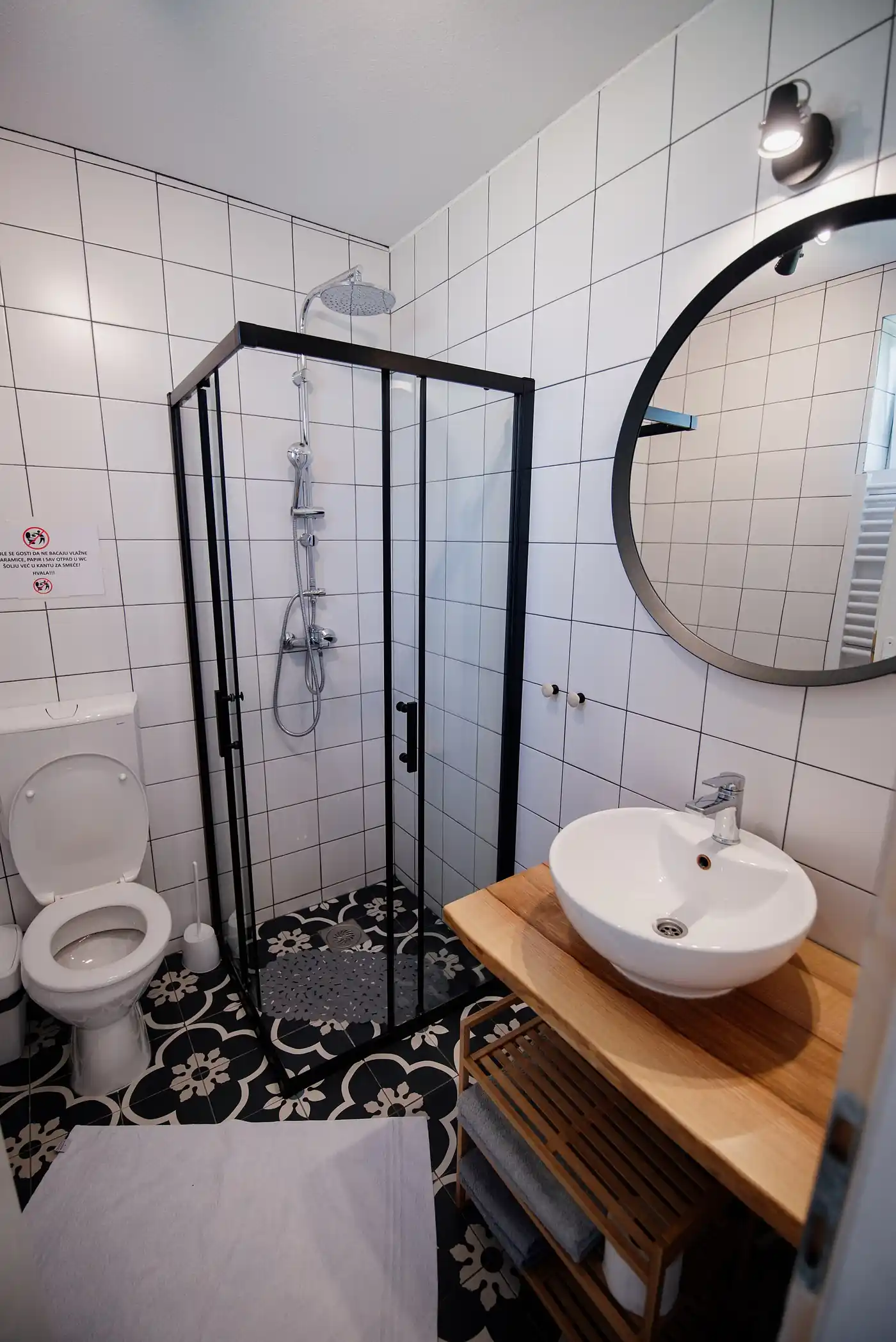 A renovated bathroom with a glass shower enclosure — design image, shared openly as an illustration