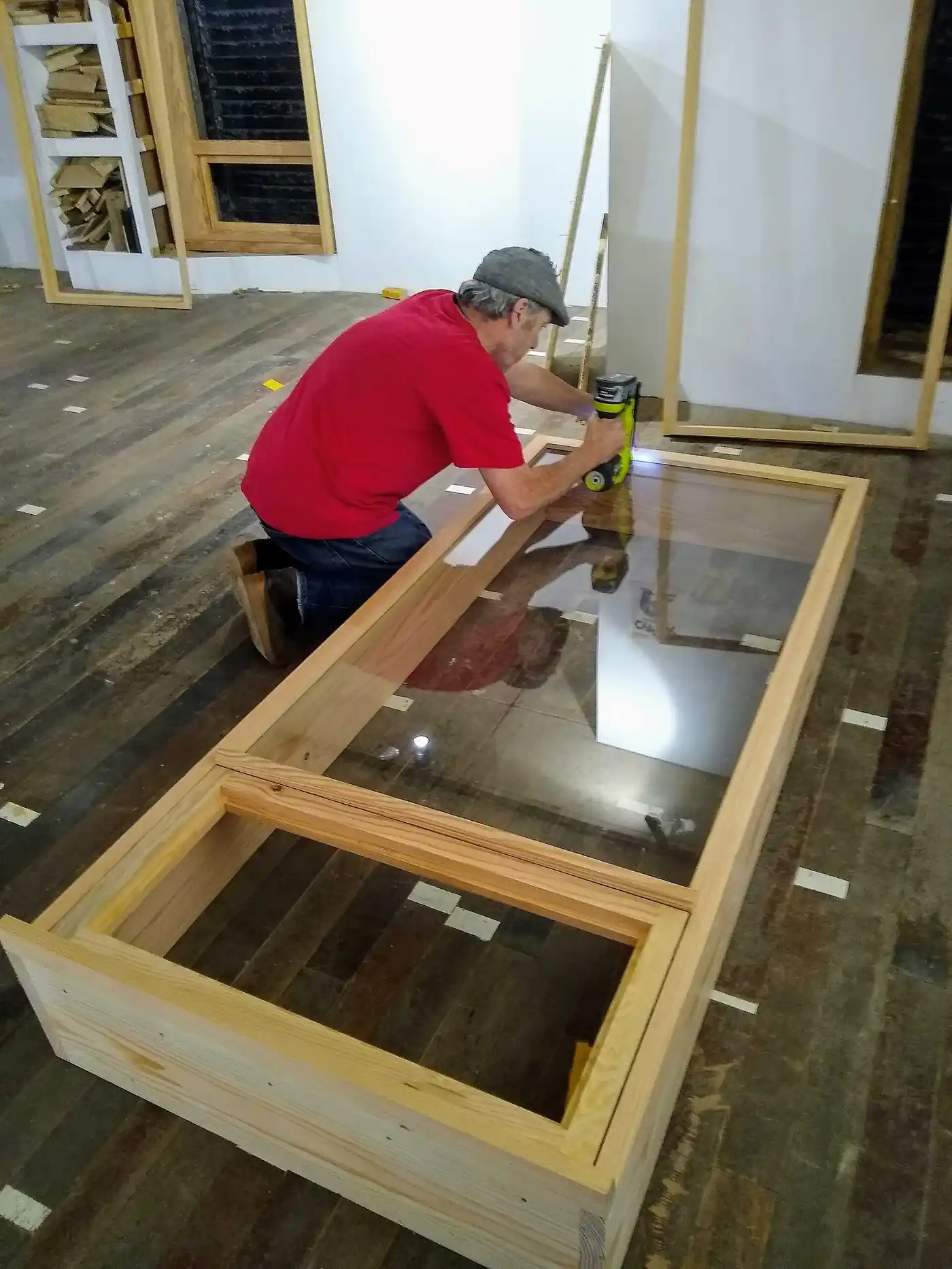 Worker fitting a glazed window frame during renovation work
