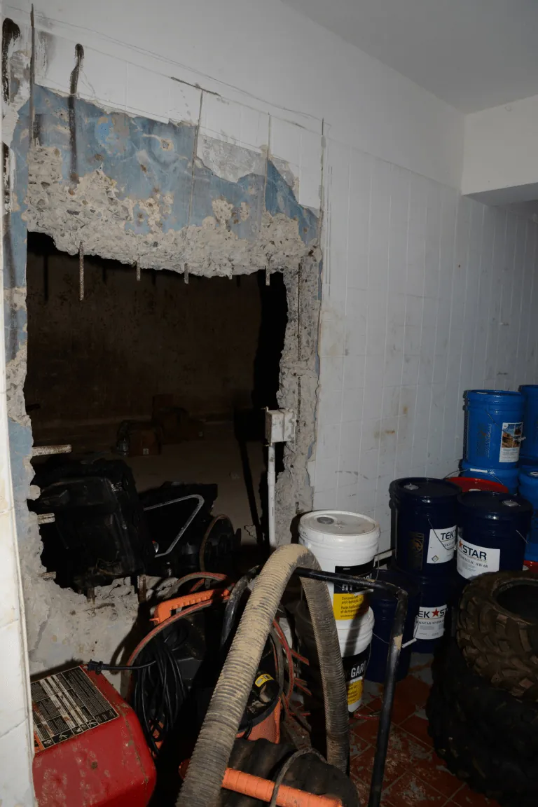 Wall with damaged plaster and peeling paint opened up during renovation