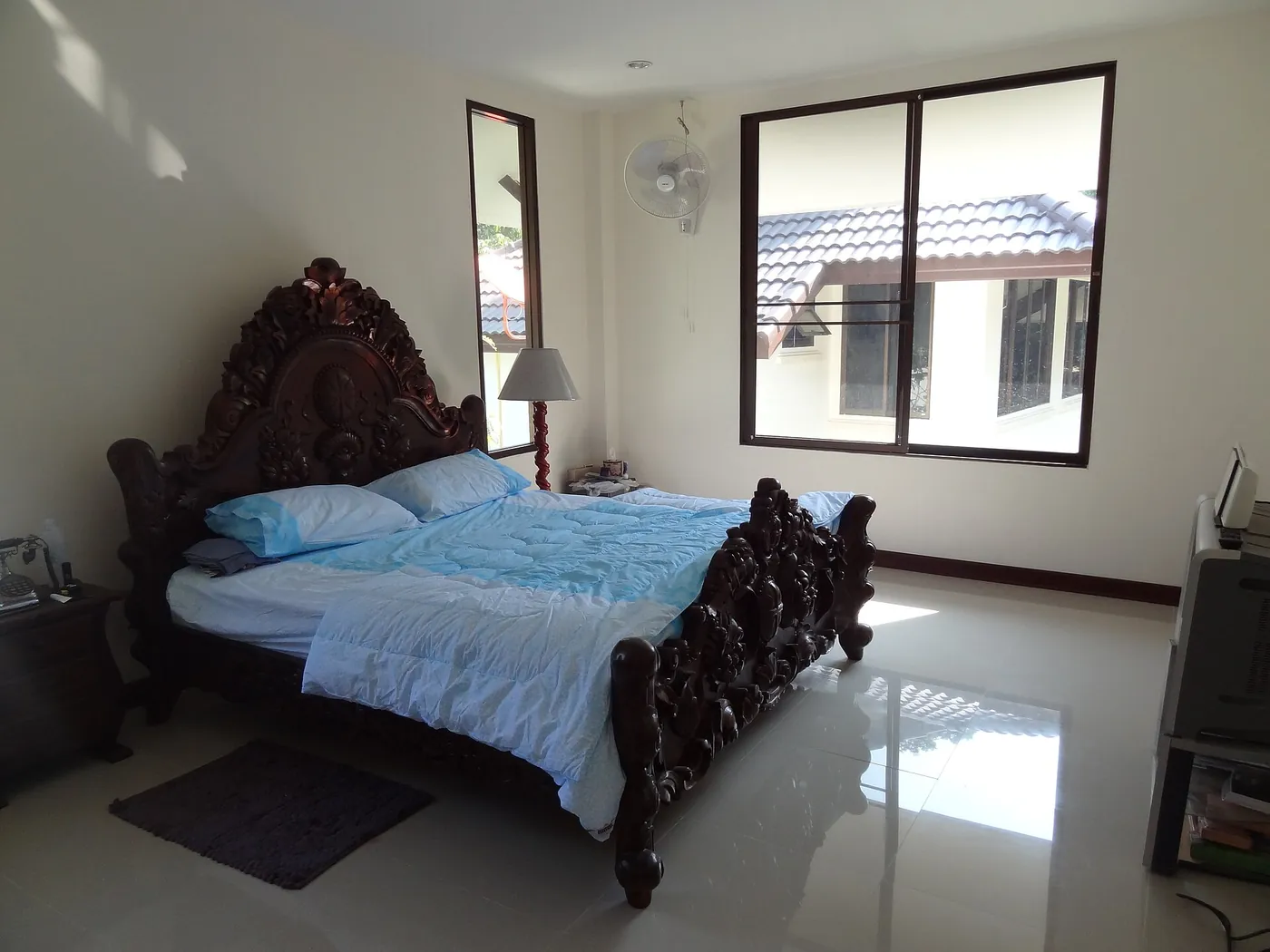 A finished bedroom with polished wood furniture — design image