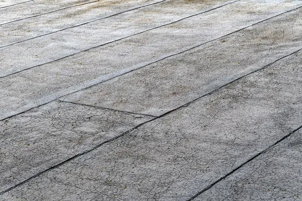 Bituminous waterproofing membrane being laid on a flat roof